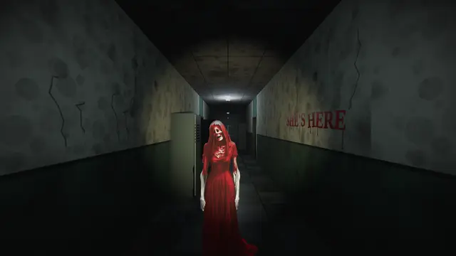 Madam Koi Koi stands in the main hallway, under SHE'S HERE written on the wall in red.